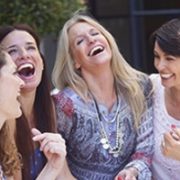 Four women laughing and talking