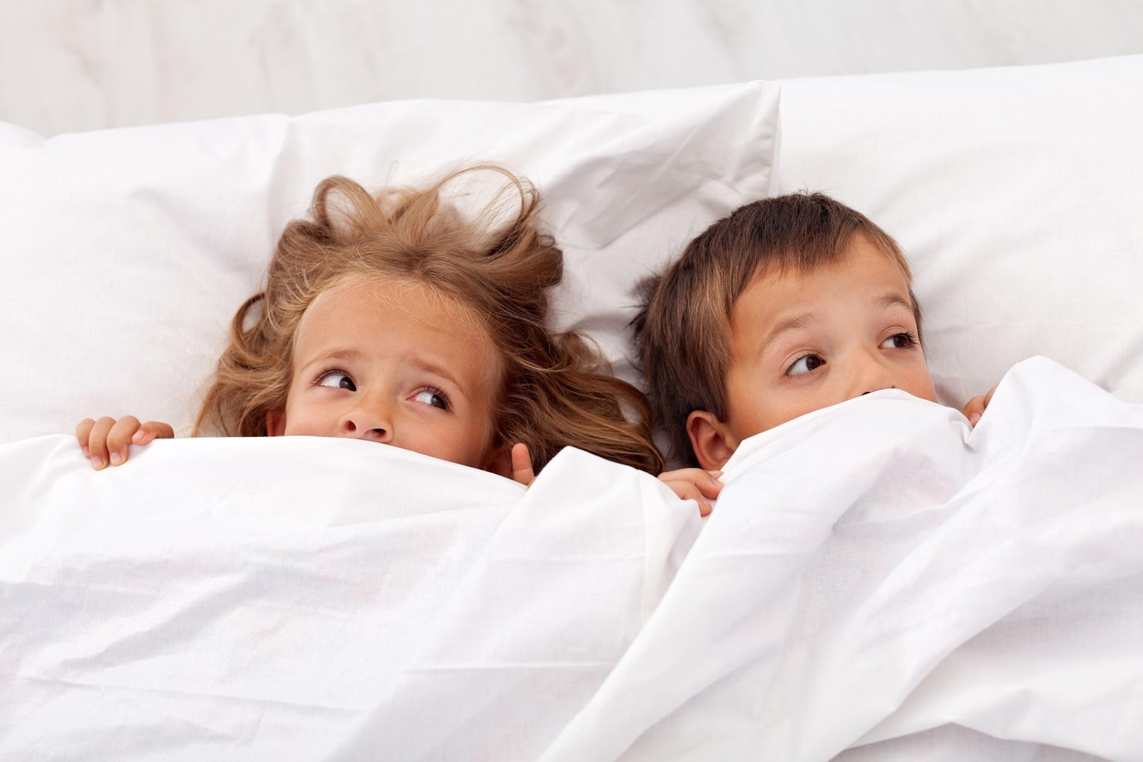 Kids in bed afraid because they do not know how to get rid of lice